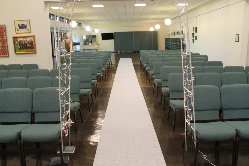 wedding aisle with lighted trellis